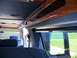 2000 Ford E150 - View of the interior of a van, showing seats and wood trim.