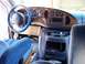 2000 Ford E150 - The interior of a 2000 Ford E150 van, blue upholstery and wood grain accents on the dashboard.