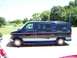 2000 Ford E150 - Side view of a dark blue Ford E-Series van with a two-tone stripe, parked on a driveway.