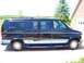 2000 Ford E150 - This 2000 Ford E150 conversion van is parked in front of a brick garage.