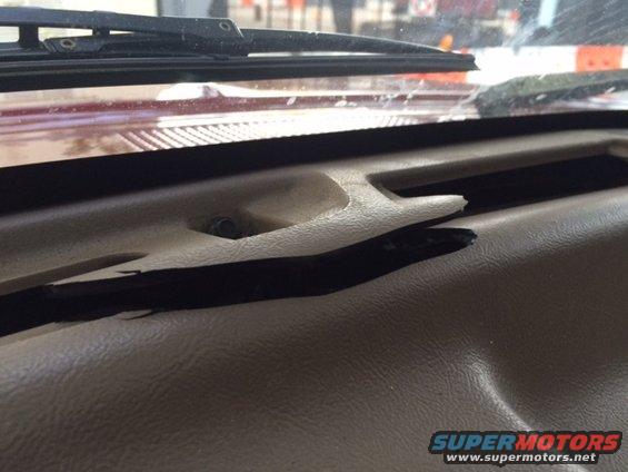 Dashboard with cracked plastic trim and visible damage