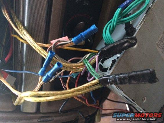 Car stereo wiring with blue wire nuts and black electrical tape