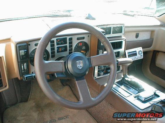1986 Pontiac Fiero interior showing dashboard, steering wheel, and center console with automatic shifter