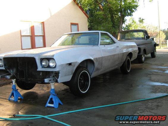 1973 Ford Ranchero on jack stands, primer finish, front end partially disassembled