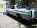 1973 Ford Ranchero - This pickup truck, likely a 1972 model, is in a state of repair with its body primed and rear end elevated on jack stands.