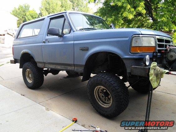 Blue 1996 Ford Bronco with lifted suspension and off-road tires