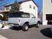 1990 Ford Bronco - Silver 1990 Ford Bronco with black top parked in a suburban driveway.