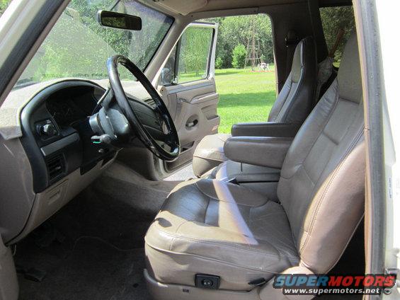 Tan leather interior of a 1994 Ford Bronco, showing front seats and dashboard