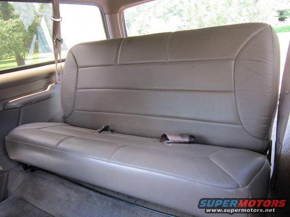 Rear bench seat with seatbelts inside a vehicle