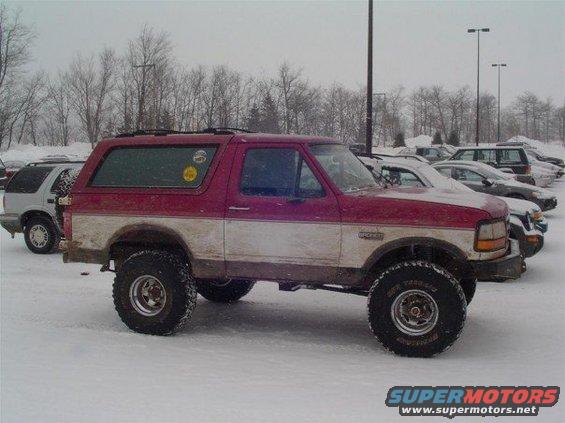 1994 Ford Bronco lifted with off-road tires parked in snow