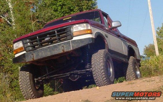 Red and silver lifted 1994 Ford Bronco front three-quarter view