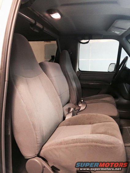 1995 Ford Bronco interior with grey cloth seats and seatbelts