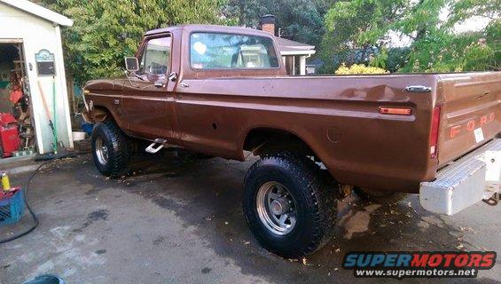 1976 Ford F-250 pickup truck, brown, lifted with off-road tires, parked in driveway
