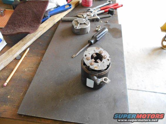 Starter motor part on a workbench with tools
