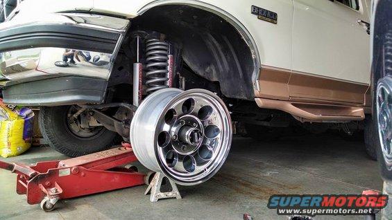 1994 Ford Bronco side view, front wheel removed, suspension visible, on jack stands