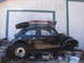 1964 Volkswagen Beetle - A modified 1964 Volkswagen Beetle sits in a garage, equipped with off-road tires and a roof rack.
