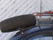 1964 Volkswagen Beetle - Spare tire and jack secured to a roof rack system.