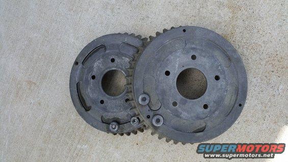 Two metal gears with teeth and bolt holes