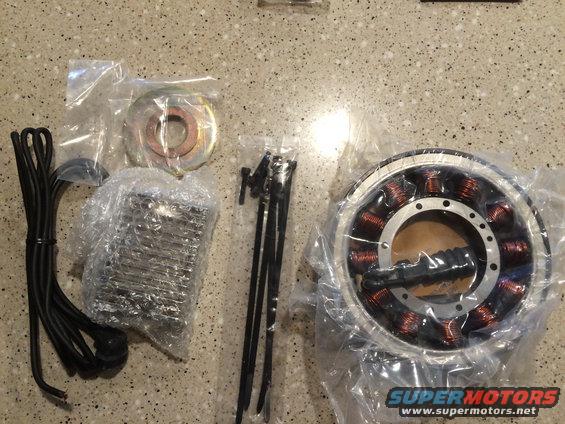 Motorcycle stator, regulator, and wiring kit laid out on a counter