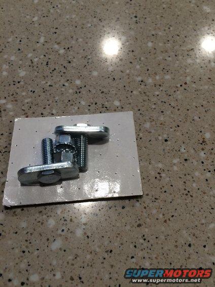 Metal hardware with bolts and nuts on cardboard