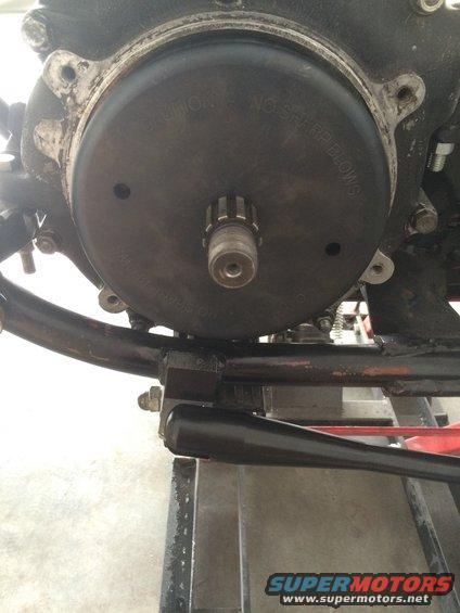 Motorcycle transmission cover with caution text and splined shaft