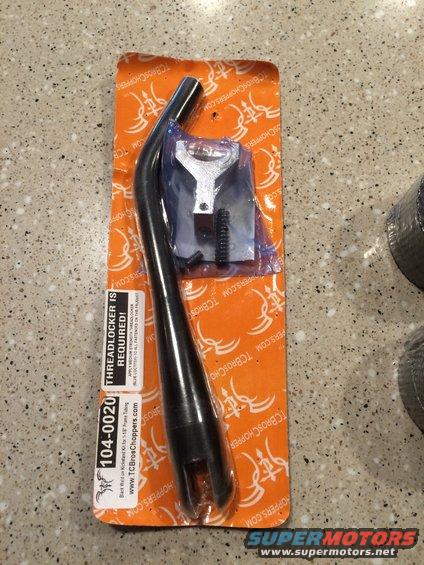 Motorcycle exhaust pipe and hardware in packaging. Label says 'TCBrosChoppers.com'