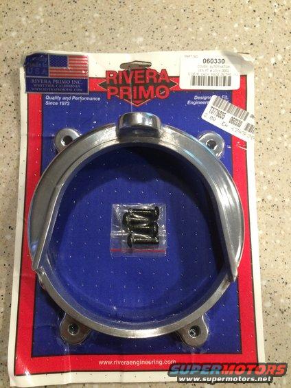 Chrome motorcycle alternator cover part in packaging with screws. Rivera Primo Inc. branding visible