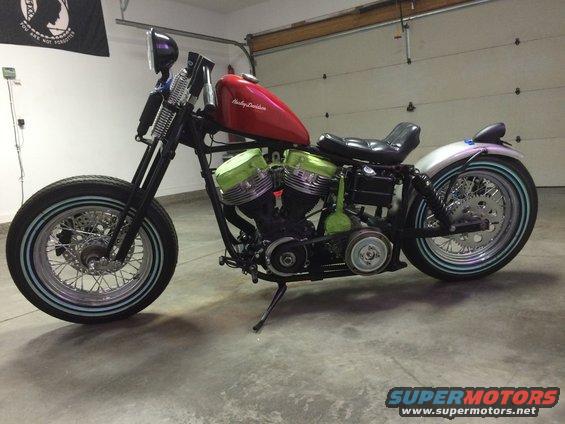 Red Harley-Davidson motorcycle with green engine covers and whitewall tires