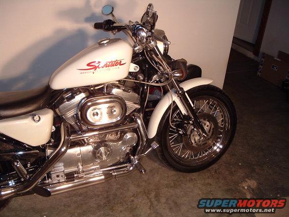 White Harley-Davidson Sportster motorcycle, front wheel and engine visible