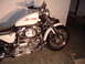 2011 Harley-Davidson Elec Gld Police - A white Harley-Davidson Sportster motorcycle is parked indoors, showing its engine and front wheel.