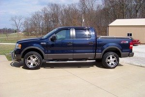 Blue 2005 Ford F-150 pickup truck, side view