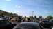 2004 Ford Crown Victoria - A gathering of vehicles and people in a parking lot under a bright blue sky.