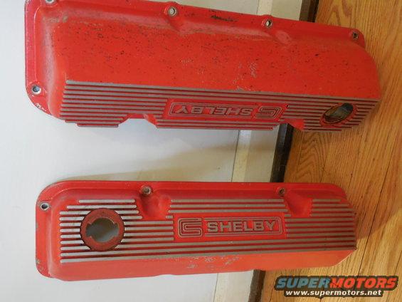 Pair of red Shelby valve covers with silver stripes and 'SHELBY' lettering