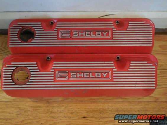 Two red Shelby valve covers with silver stripes and lettering