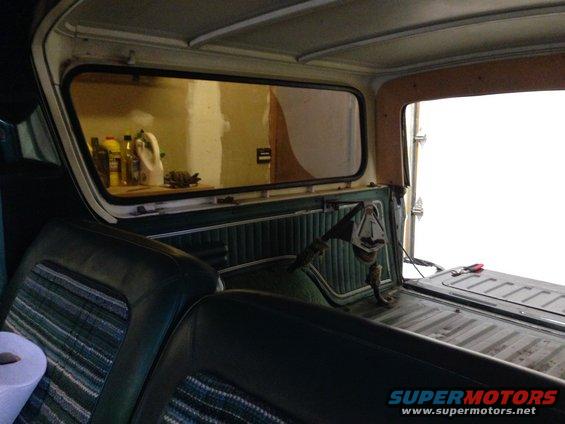 1979 Ford Bronco interior showing rear bench seat, patterned seat inserts, and cargo area