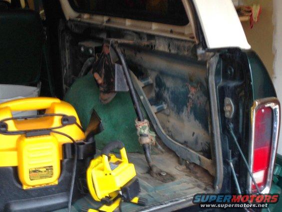 1979 Ford Bronco interior with yellow shop vac and work light