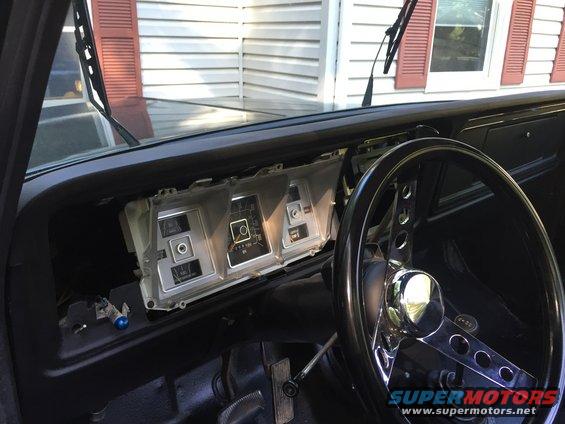 1979 Ford Bronco dashboard with exposed wiring and aftermarket steering wheel