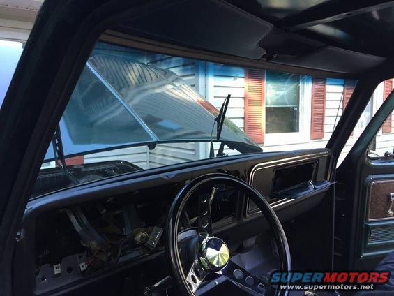 Interior view of a vehicle with the hood up, showing the dashboard and steering wheel