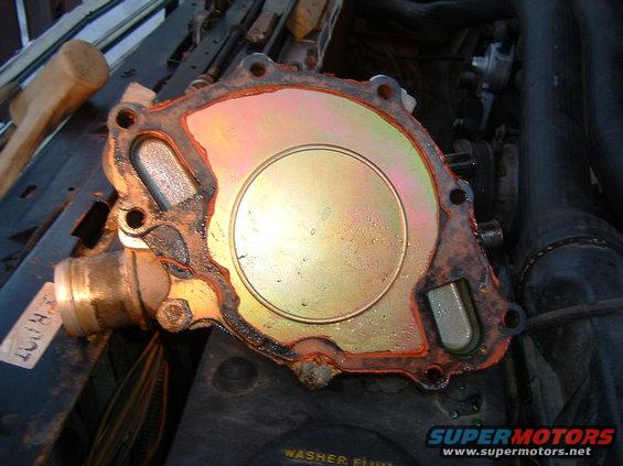 close-up of a used water pump with orange gasket sealant