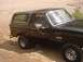 1988 Ford Bronco - 1988 Ford Bronco parked on a dirt surface, showing its side profile and removable hardtop.