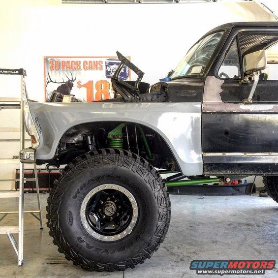 Modified truck fender and large tire with green suspension components
