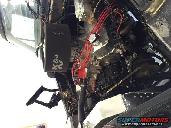 Engine bay with K&N air filter and red spark plug wires