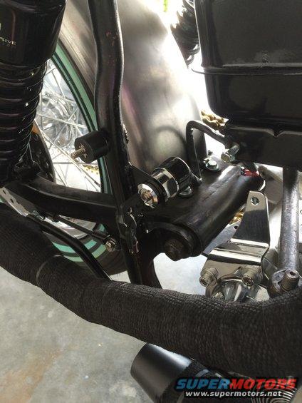 Motorcycle frame detail with ignition switch and black exhaust wrap