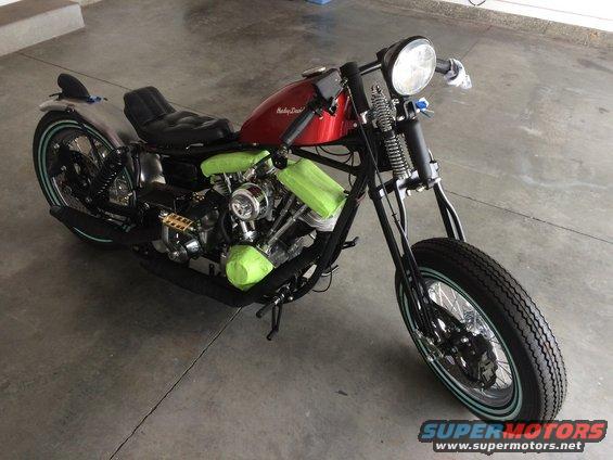 Custom Harley-Davidson motorcycle with red tank and green engine covers