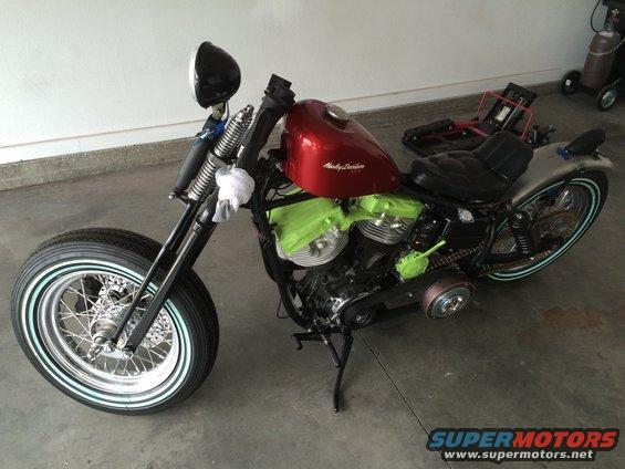 Red Harley-Davidson motorcycle, 3q-front view, with green engine covers