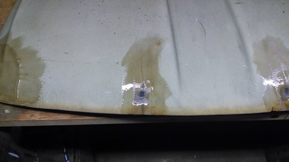 Another weak spot to deal with. Used some fiberglass mesh tape and resin to reinforce. I'll deal with the hole from the other side.
