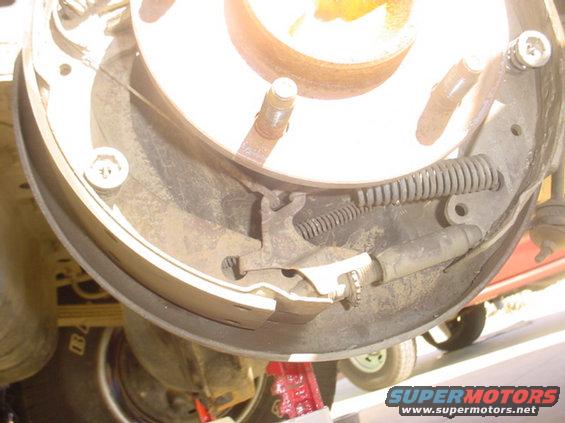 Rear drum brake assembly with springs and brake shoes