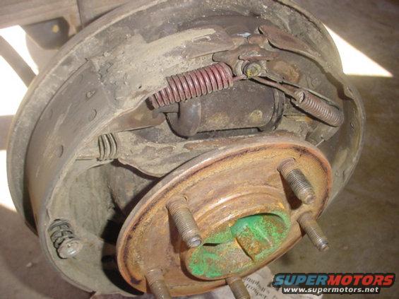 Close-up of a rusty drum brake assembly with springs and brake shoes