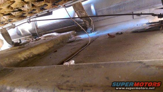 Interior floor view of a vehicle with visible seat springs and debris