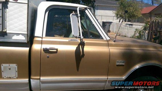 1968 Chevrolet C/K Pickup truck, gold and white, with a camper shell